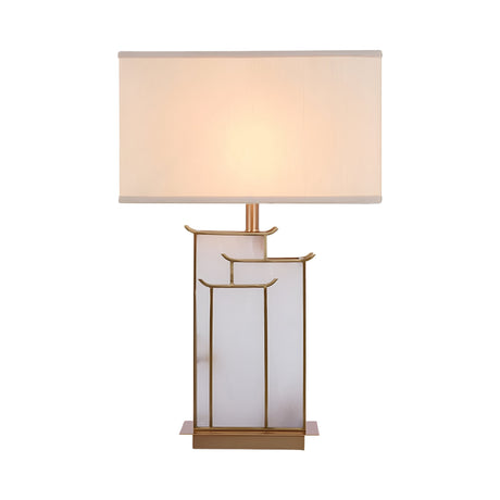 The Veliora 1 Light Framed Alabaster Table Lamp in brass and soft white features a geometric gold and frosted glass base with a rectangular white shade, showcasing clean lines and minimalist design against a white background.