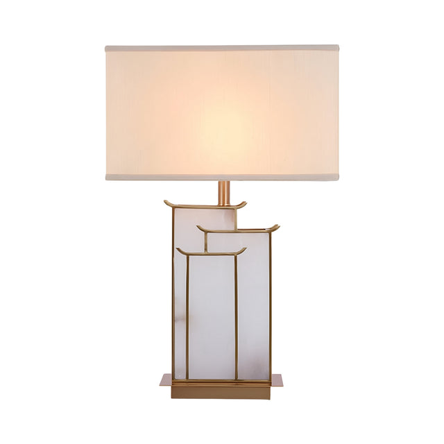 The Veliora 1 Light Framed Alabaster Table Lamp in brass and soft white features a geometric gold and frosted glass base with a rectangular white shade, showcasing clean lines and minimalist design against a white background.