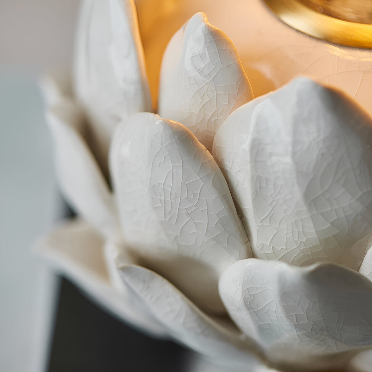 Aldgrove Table Lamp base close-up, artichoke-shaped ceramic petals in oatmeal crackle glaze with antique brass neck detail.