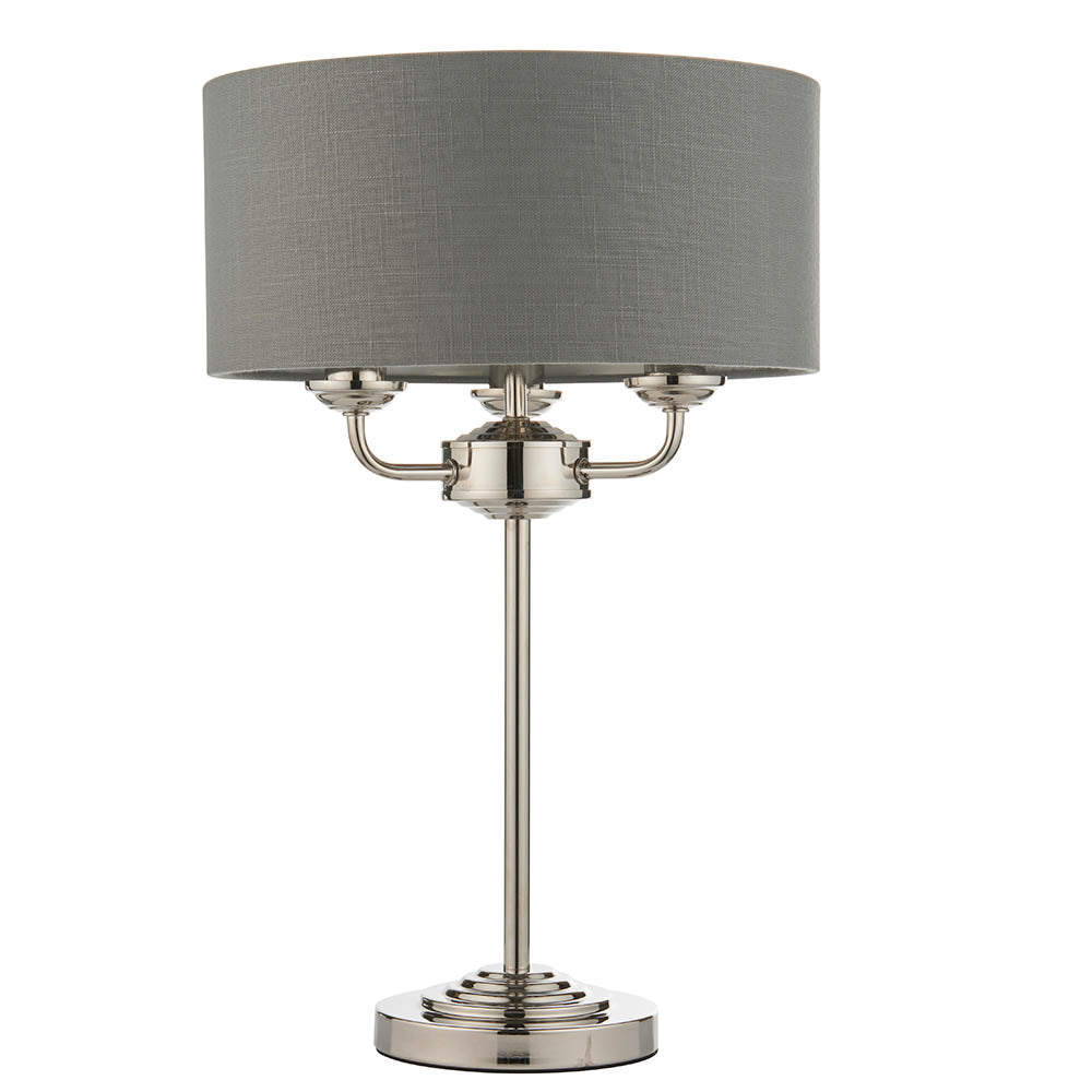 Endon Brenley 3 Light Table Lamp in nickel with a grey linen drum shade, three E14 lamp holders and a stepped circular base, on a white background.
