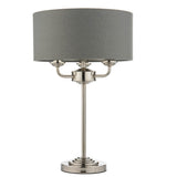 Endon Brenley 3 Light Table Lamp in nickel with a grey linen drum shade, three E14 lamp holders and a stepped circular base, on a white background.
