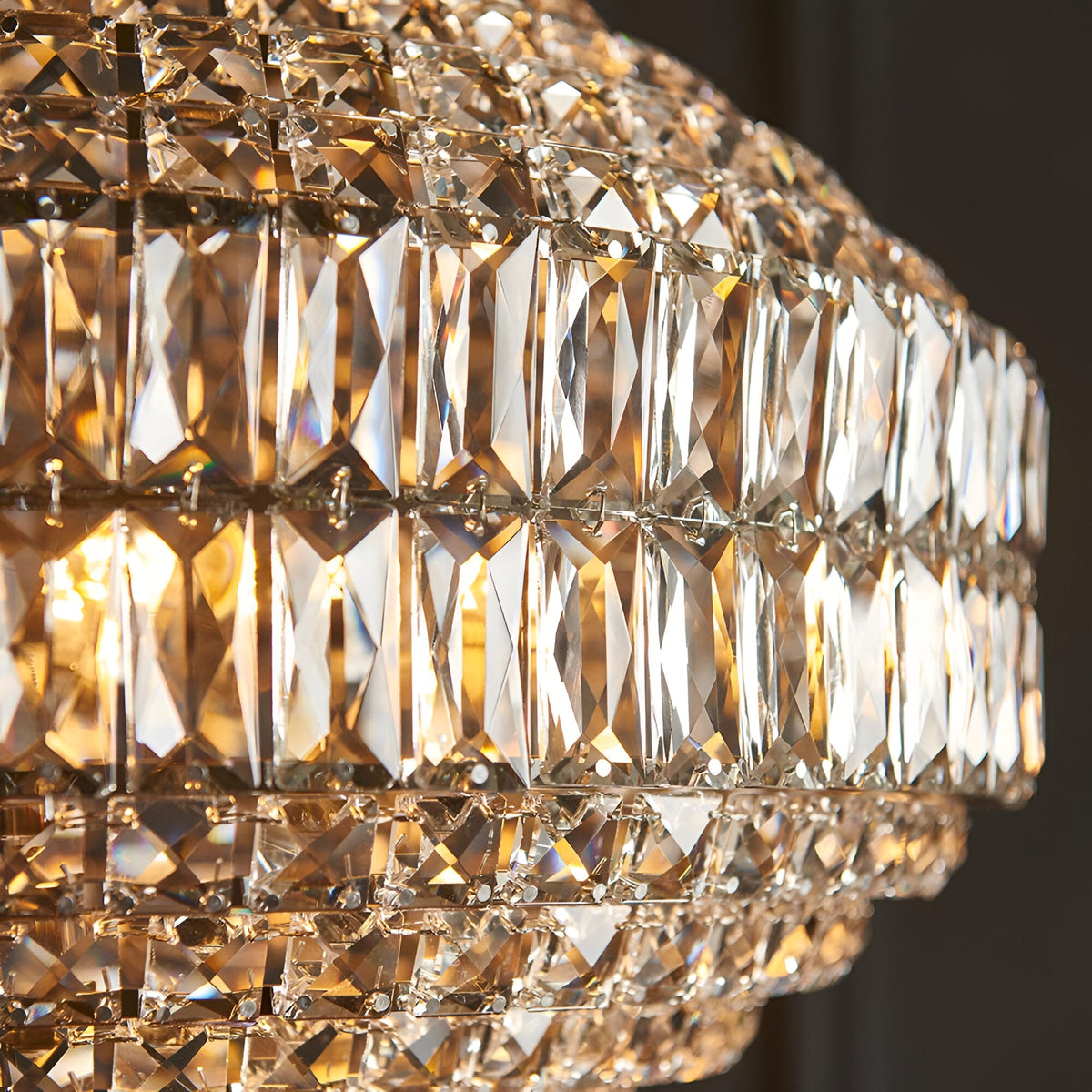 Close-up of the Endon Aldton 5 light pendant showing tiered clear faceted crystals on polished nickel plated metalwork with illuminated E14 lamps.