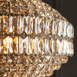 Close-up of the Endon Aldton 5 light pendant showing tiered clear faceted crystals on polished nickel plated metalwork with illuminated E14 lamps.