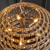 Close-up of the Endon Aldton 5 Light Pendant showing tiered rings of clear faceted crystals around polished nickel arms with lit E14 candle bulbs.