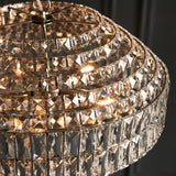 Close-up of the Endon Aldton 5 Light Pendant showing tiered rings of clear faceted crystals on a polished nickel frame with illuminated lamps inside.