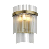 Beaumont Wall Light in brass with clear glass rods forming a tiered fringe around a central bulb, shown lit against a plain white background.