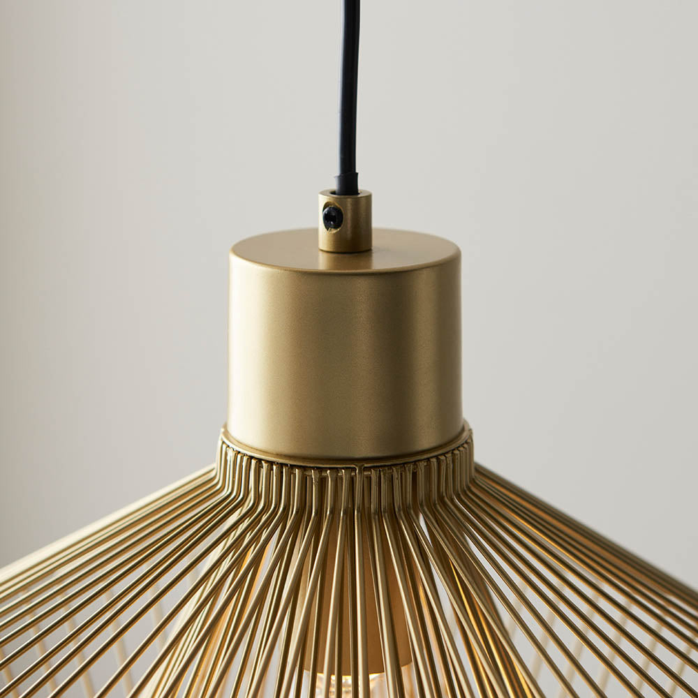 Close-up of the Endon Brockton Cage Pendant Light in polished gold, showing the cylindrical ceiling cap, black flex, and top of the wire cage shade.