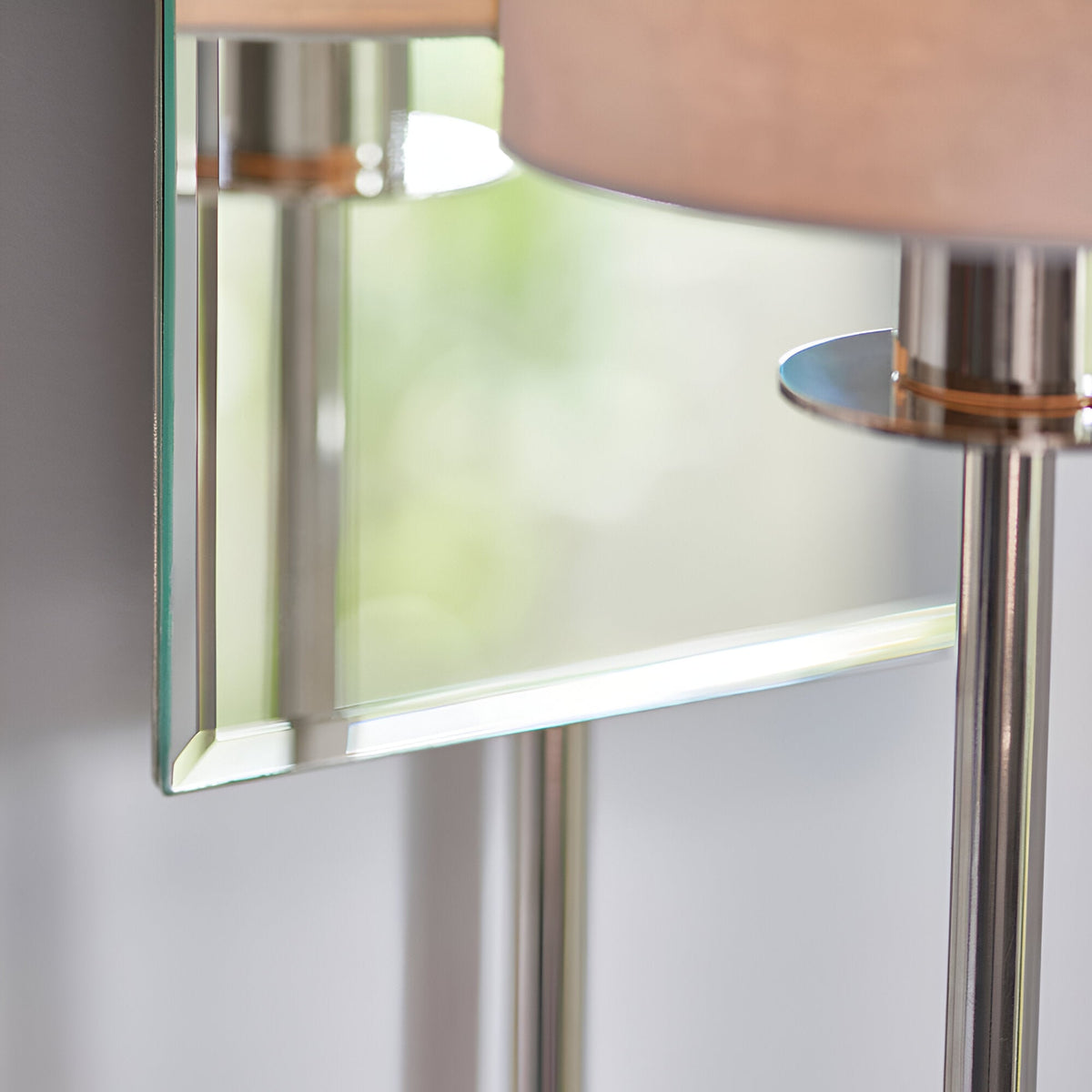 Close-up of the Endon Carlhurst wall light showing the bevelled mirrored back plate, polished nickel arm and vintage white fabric cylinder shade.