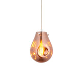 Brackwell Glass Pendant in Copper, a single-light fixture with a fluid teardrop-shaped shade, chrome fittings, and grey fabric cable.