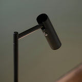 Close-up of the Endon Brackbourne floor lamp's adjustable cylindrical head in matt black, with push button switch on the tilting arm.