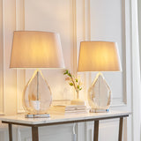 Brockstead Table Lamp Twin Pack in Gold, dimpled teardrop glass bases on chrome metalwork with mink oval shades, styled on a console table.