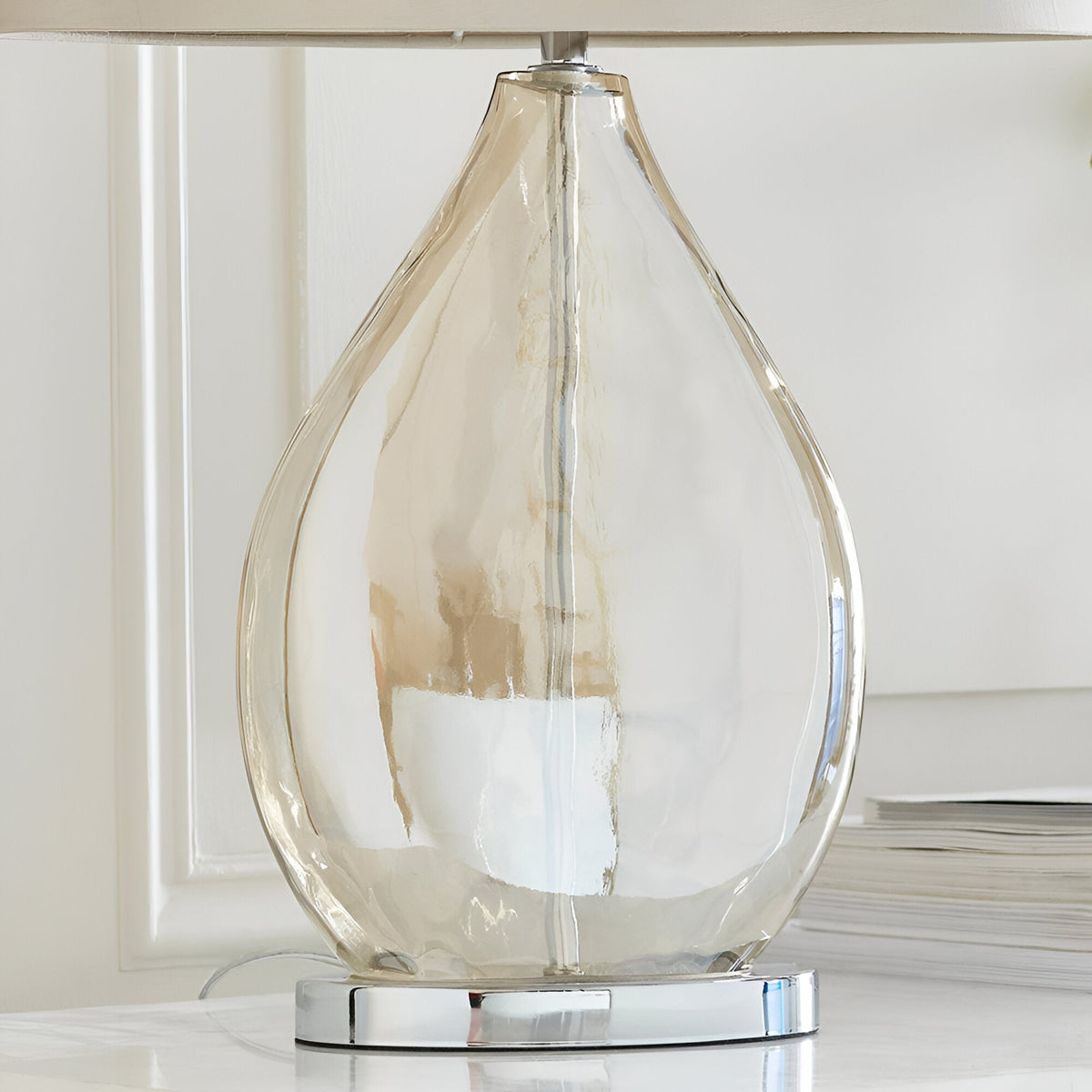 Brockstead Table Lamp with gold-tinted dimpled teardrop glass body on a chrome base, shown close-up beneath an oval mink fabric shade.
