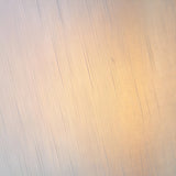 Close-up of a textured metallic surface in warm gold and neutral tones, showing fine linear detailing on the Brockstead Table Lamp Twin Pack - Gold.