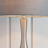 Close-up of the Endon Chartbury LED table lamp's slim satin nickel base and grey fabric drum shade.