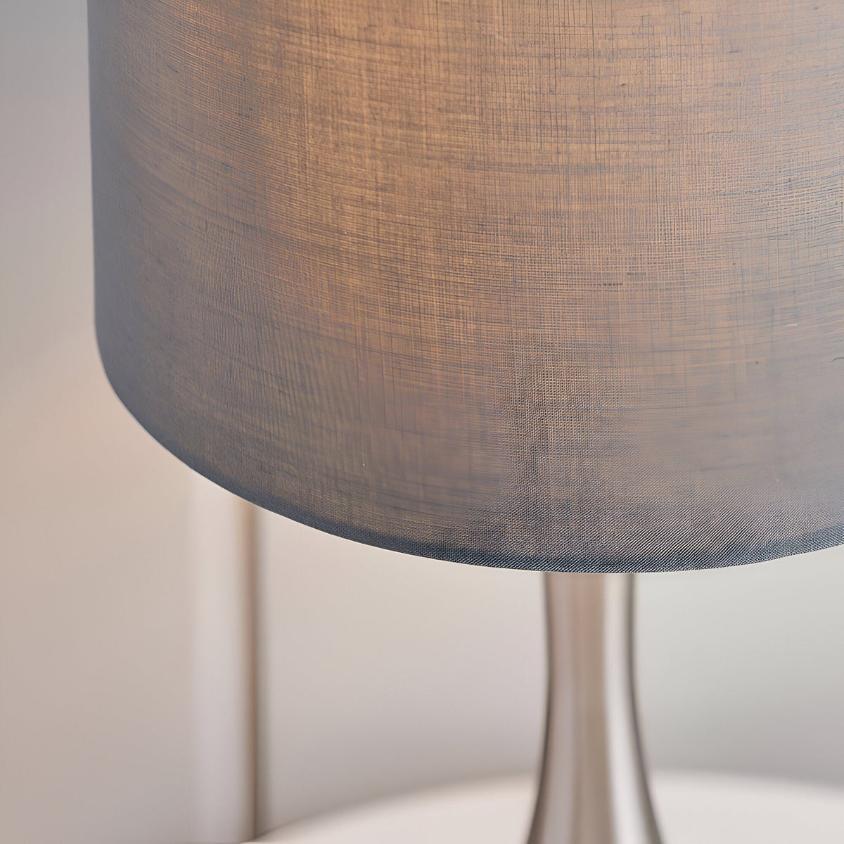 Close-up of the Endon Chartbury LED table lamp's grey fabric drum shade and satin nickel base.