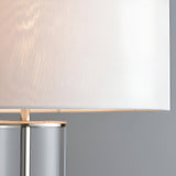 Close-up of the Endon Caldley table lamp showing the vintage white fabric drum shade and clear cylindrical glass base with nickel fitting.