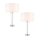 Endon Caldley twin pack table lamps with clear cylindrical glass bases, nickel fittings and vintage white faux silk drum shades on a white background.