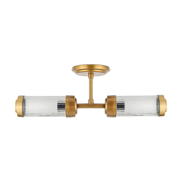 Akurdi 2 Light Bathroom Wall Light in Clear, with two ribbed glass cylinders capped in brass, mounted on a round brass wall plate, shown on a plain white background.