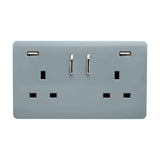 Cool grey 2 gang double 13A socket with a flat screwless plate, chrome rockers, and two USB-A charging ports at the top corners, shown on a plain white background.