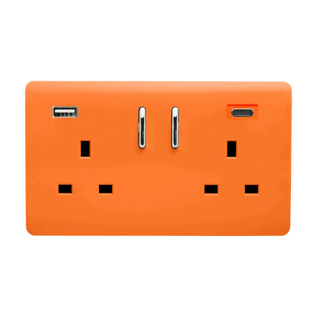 Two gang 13A switched socket in orange with chrome rockers, featuring a USB-A and USB-C port between the outlets, screwless plate, shown on a white background.