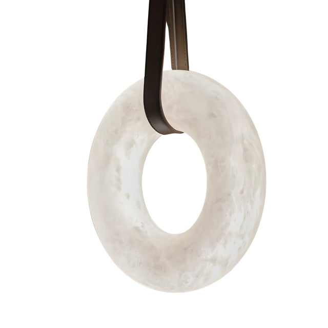 The Cintura LED Large Alabaster Single Pendant Light in soft white and brown features a marble-like texture and hangs from two curved supports, offering elegant ambient lighting for any space.
