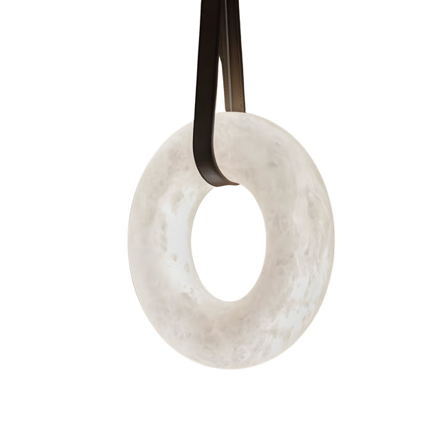 The Cintura LED Small Alabaster Single Pendant Light in soft white and brown is suspended by two black straps against a plain white background.