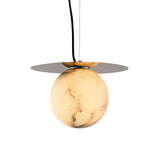 The Marenzo 1 Light Small Orb Alabaster Single Pendant Light in Soft White & Brushed Brass features a round, marble-patterned globe and a flat brass disc above, suspended by a black cord against a white background.