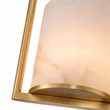 Close-up of the Halorin 1 Light Framed Alabaster Single Pendant Light featuring a soft white cylindrical shade with subtle marbling and a brushed brass frame, emitting warm, inviting light.