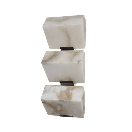 The Glorina LED Large Stacked Alabaster Wall Light – Soft White features three rectangular alabaster blocks in soft white, separated by dark metal brackets and stacked vertically for a sculptural look against any background.