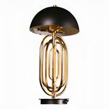 The Ascot 4 Light Large Table Lamp in black and gold features a modern Art Deco design with a shiny gold tuba-shaped base and a round black shade, offering adjustable lighting against a plain white background.