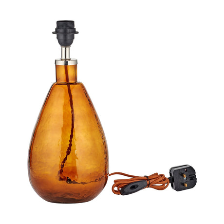 Baba Small Tall Recycled Glass Lamp Base in burnt amber, a teardrop-shaped hammered glass base with chrome collar and black E27 bulb holder, orange cord with UK plug, on a plain white background.