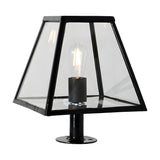 Small contemporary pillar light in black steel with a tapered glass panel shade, exposed E27 bulb, and pedestal base plate, shown on a plain white background.