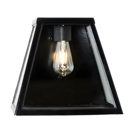 Contemporary black bulkhead wall light with tapered glass panels and exposed exposed ST64 filament bulb, shown front-on against a plain white background.