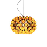 The Briller LED Small Pendant Light - Gold is a modern dome-shaped fixture with clustered amber acrylic spheres, suspended by a thin black cord, perfect for adding style to any space.