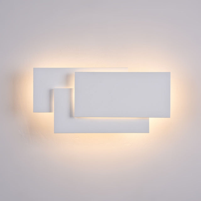 White Trame LED wall light, providing a soft glow, suitable for contemporary wall lighting.