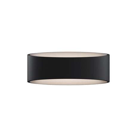 Trame LED wall light in black, emitting a warm glow suitable for accent lighting.