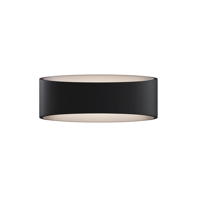 Trame LED wall light in black, emitting a warm glow suitable for accent lighting.