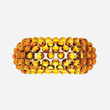 A broad, textured bracelet crafted from circular amber-colored beads is intricately arranged in a pattern that creates a layered effect. It features a gleaming gold finish with a rich, warm tone reminiscent of the soft glow emitted by the Briller LED Large Wall Light - Gold.