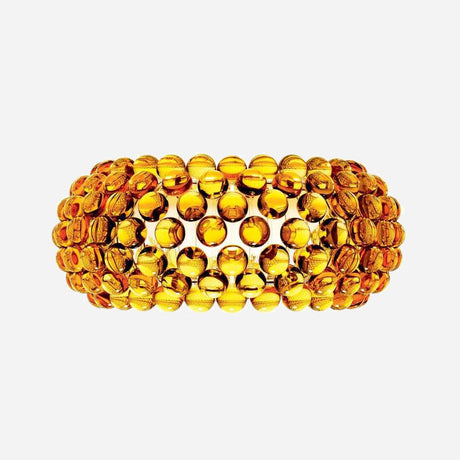 A broad, textured bracelet crafted from circular amber-colored beads is intricately arranged in a pattern that creates a layered effect. It features a gleaming gold finish with a rich, warm tone reminiscent of the soft glow emitted by the Briller LED Large Wall Light - Gold.