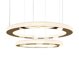 Two modern Celine LED 2 Tier Suspension Lights in gold, featuring illuminated circular rings suspended by thin wires against a white background. The overlapping tiers create a luxurious and contemporary lighting design.