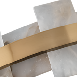 Close-up of overlapping white and gray marble-like panels, echoing the Montyra LED Panelled Alabaster Linear Chandelier in Soft White & Brass, with a diagonal brushed brass strip, set against a white background.