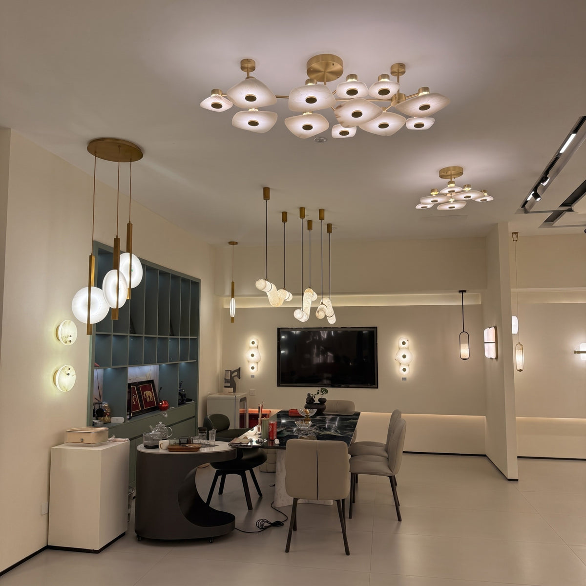 Calyra Large LED Alabaster Semi-Flush Ceiling Light in brass, shown with twelve layered alabaster panels illuminated above a dining and living area.