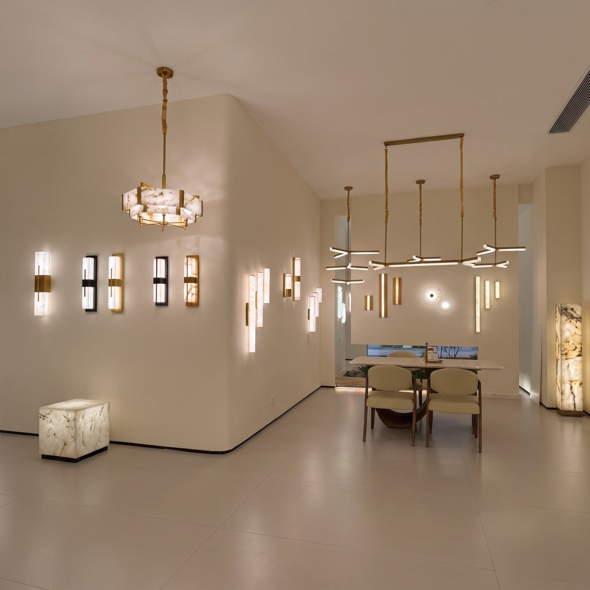 Caldera Large Alabaster Wall Light in matt black, shown among multiple vertical alabaster wall lights and pendants in a modern showroom with dining area.