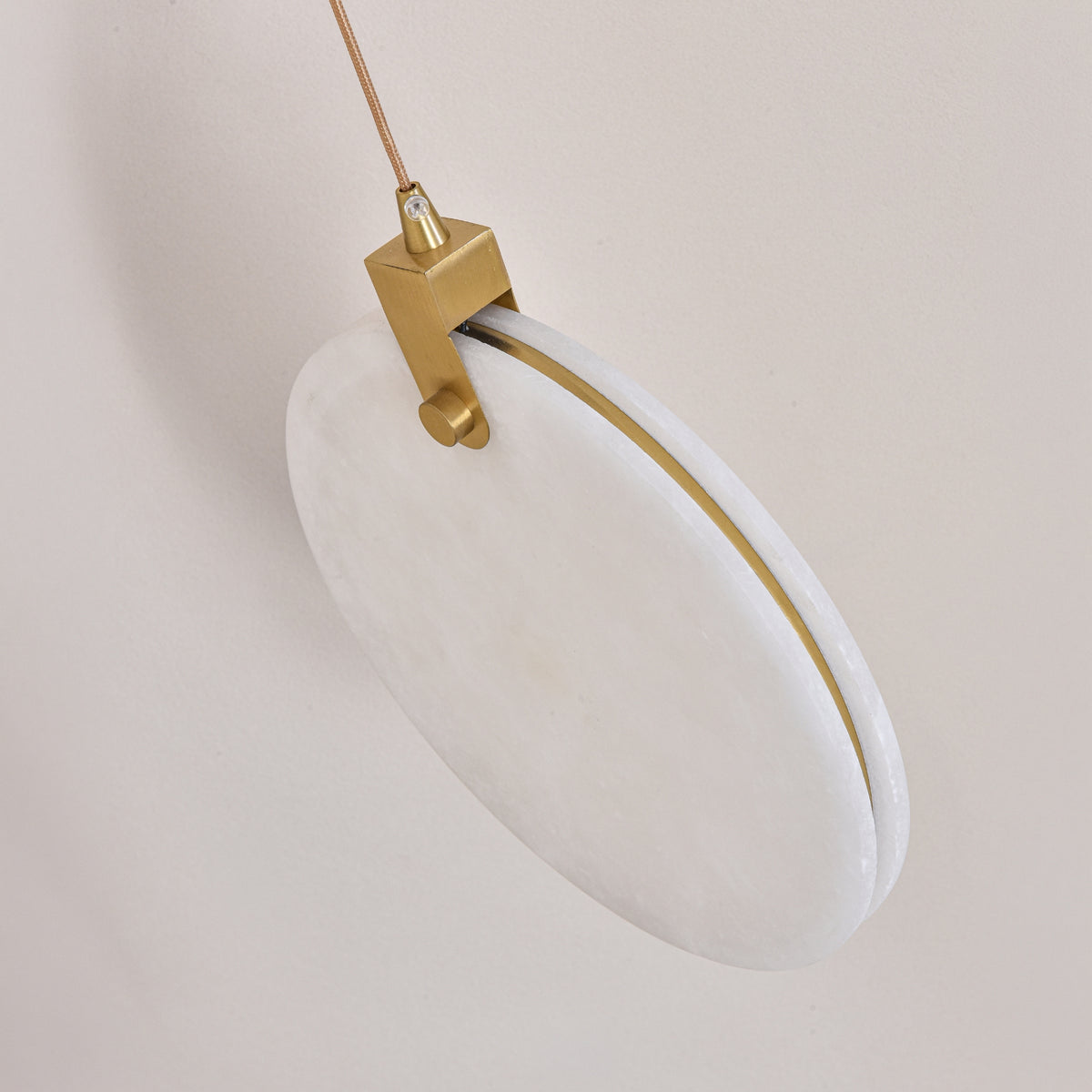 Luna LED Alabaster Disc Pendant Light, 200mm circular white alabaster shade with brushed brass rim and hinge, suspended on a slim cable against a plain light background.