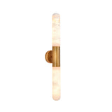 Averin LED Alabaster Wall Light in Brushed Brass, featuring two illuminated vertical alabaster columns joined by a cylindrical brass bracket, shown on a plain white background.