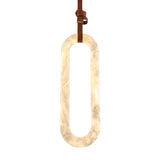Serava Large LED Alabaster Pendant Light in soft white, an elongated capsule-shaped natural stone shade suspended by a tan leather strap, shown on a plain white background.