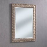 The Crown Rectangle Wall Mirror - Silver features an ornate rectangular design with a stunning silver frame, beautifully displayed against a light gray textured wall. The intricate carvings and modern elements combine timeless elegance with versatile charm.