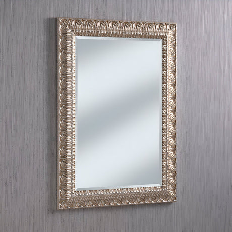 The Crown Rectangle Wall Mirror - Silver features an ornate rectangular design with a stunning silver frame, beautifully displayed against a light gray textured wall. The intricate carvings and modern elements combine timeless elegance with versatile charm.