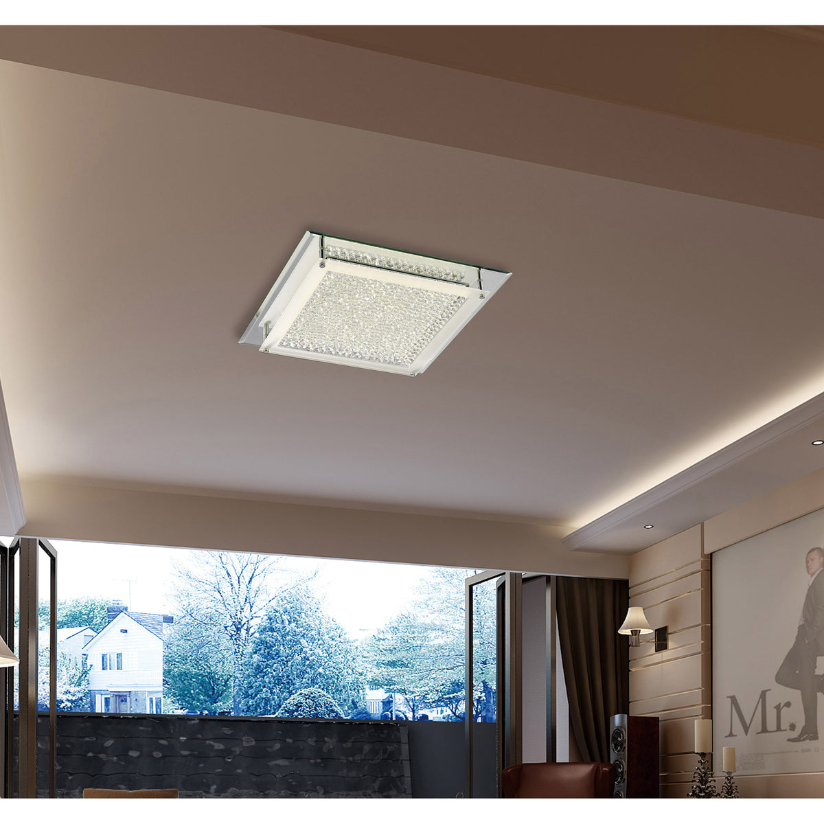 Gina 21W square flush ceiling light, 42cm crystal glass panel in a polished chrome frame, fitted flush in a light living room ceiling above an open balcony view.
