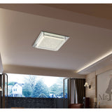 Gina 21W square flush ceiling light, 42cm crystal glass panel in a polished chrome frame, fitted flush in a light living room ceiling above an open balcony view.